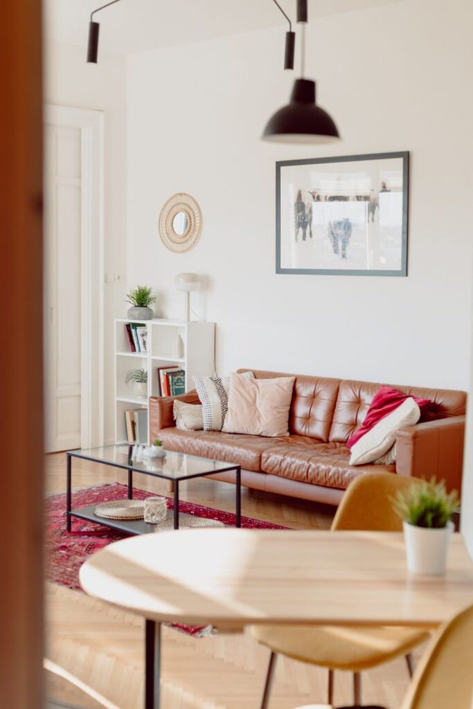 Stylish and cozy living room featuring a brown leather sofa, perfect for relaxing.