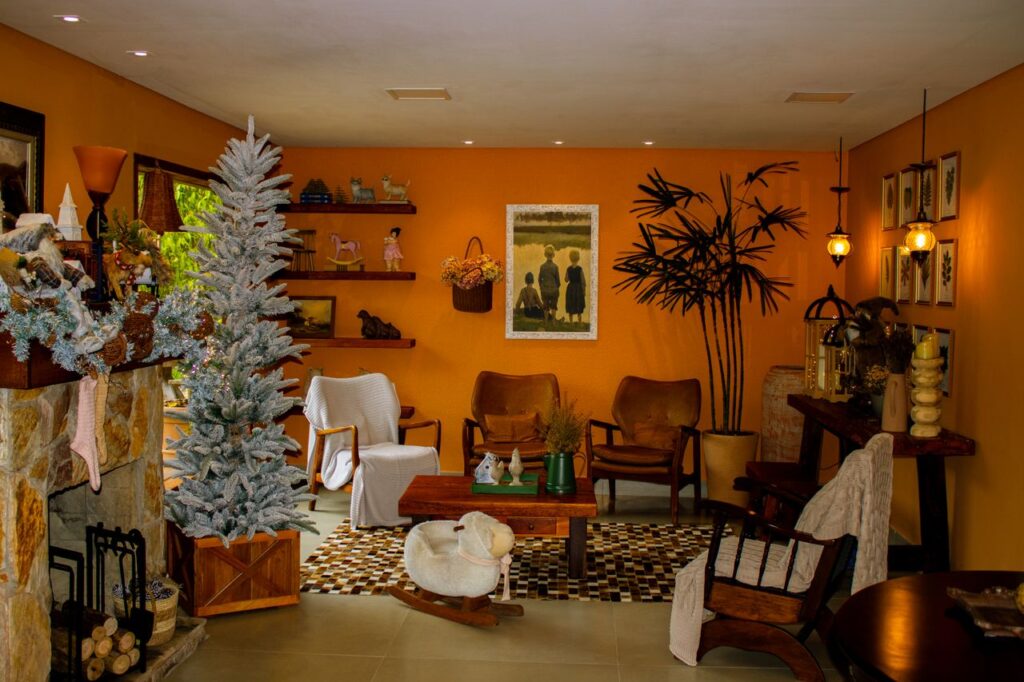 Warm living room with festive decorations and vintage furniture, creating a cozy atmosphere.